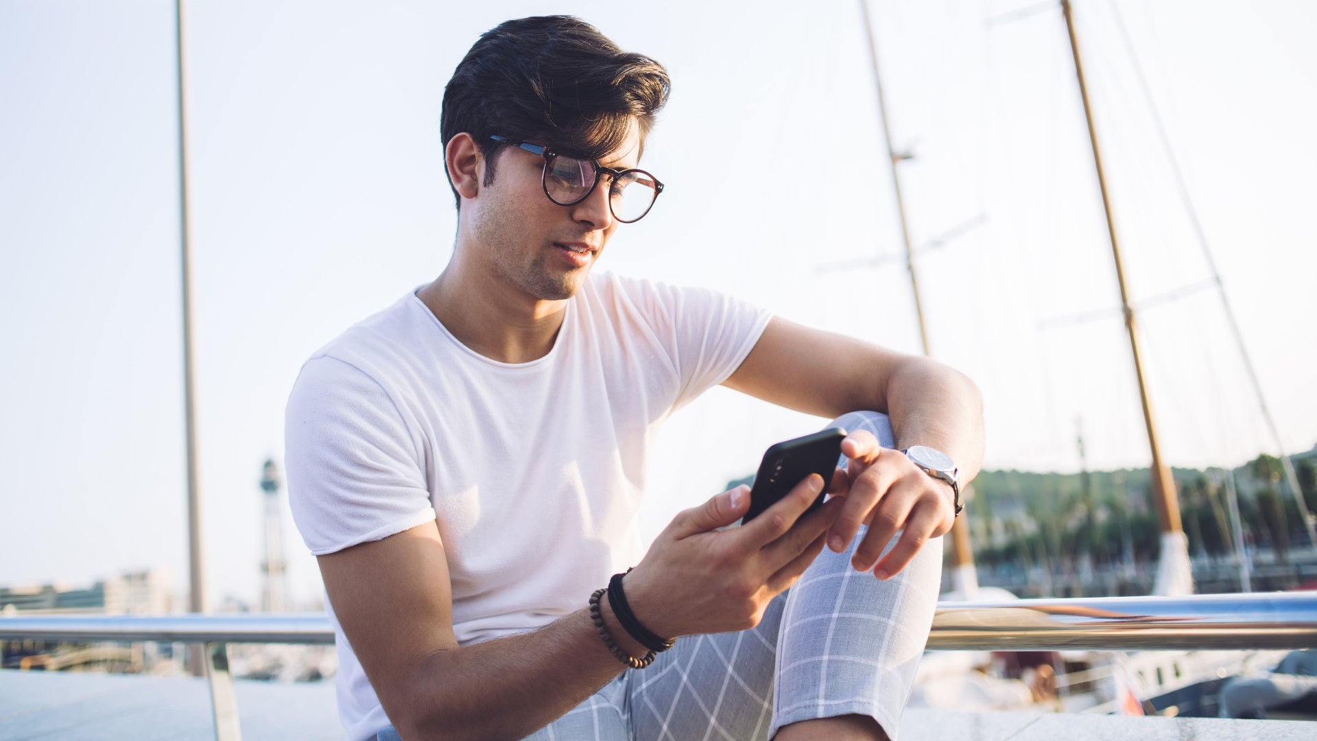 Person with smartphone on boat