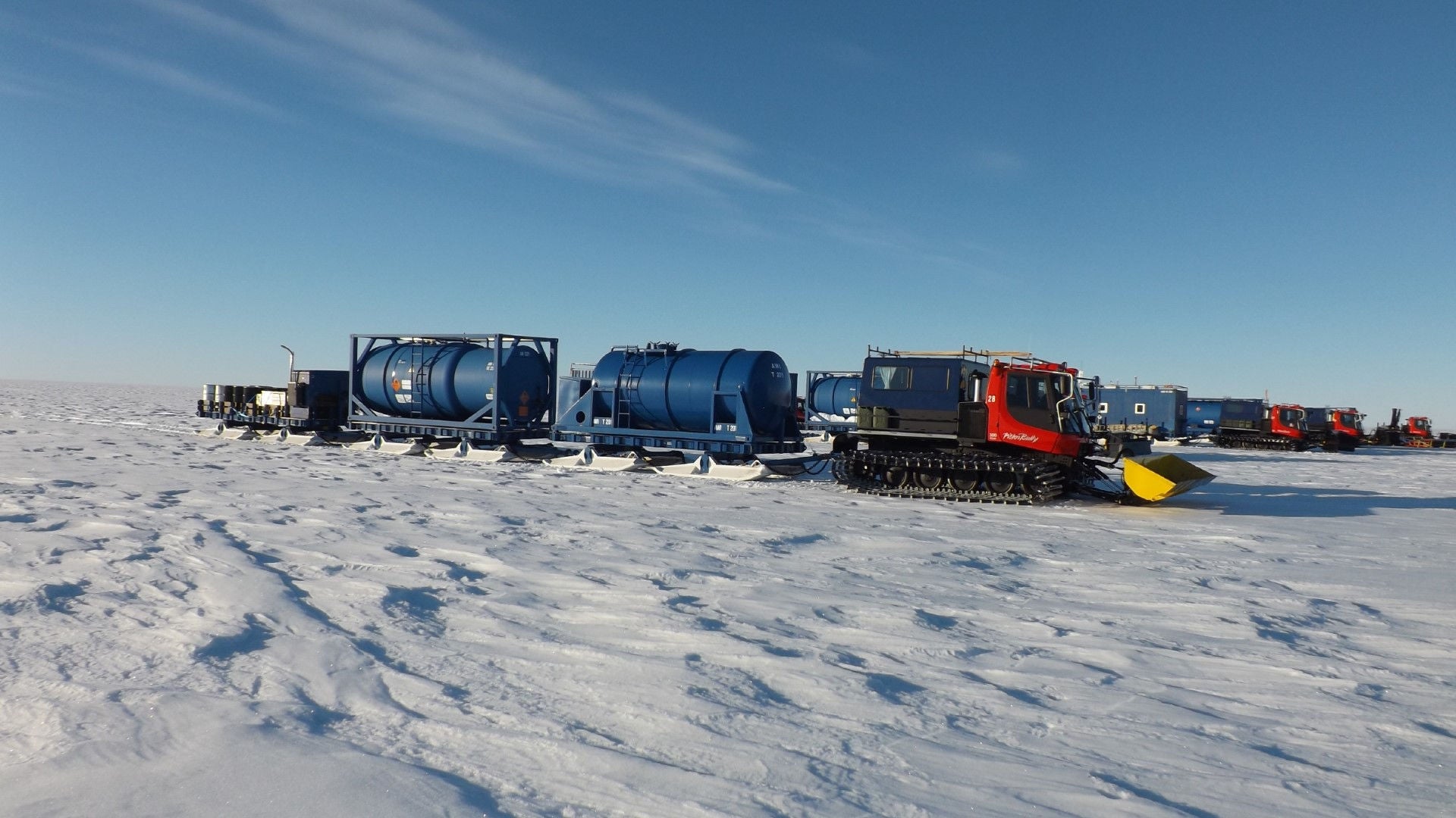 Snow groomers in antarctica pulling supplies