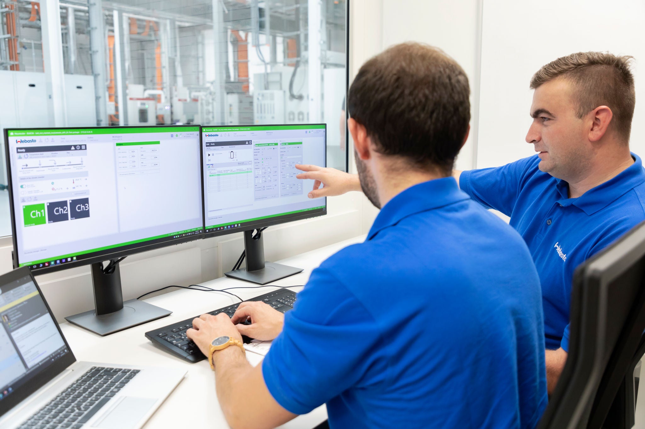 2 men in a battery testing room