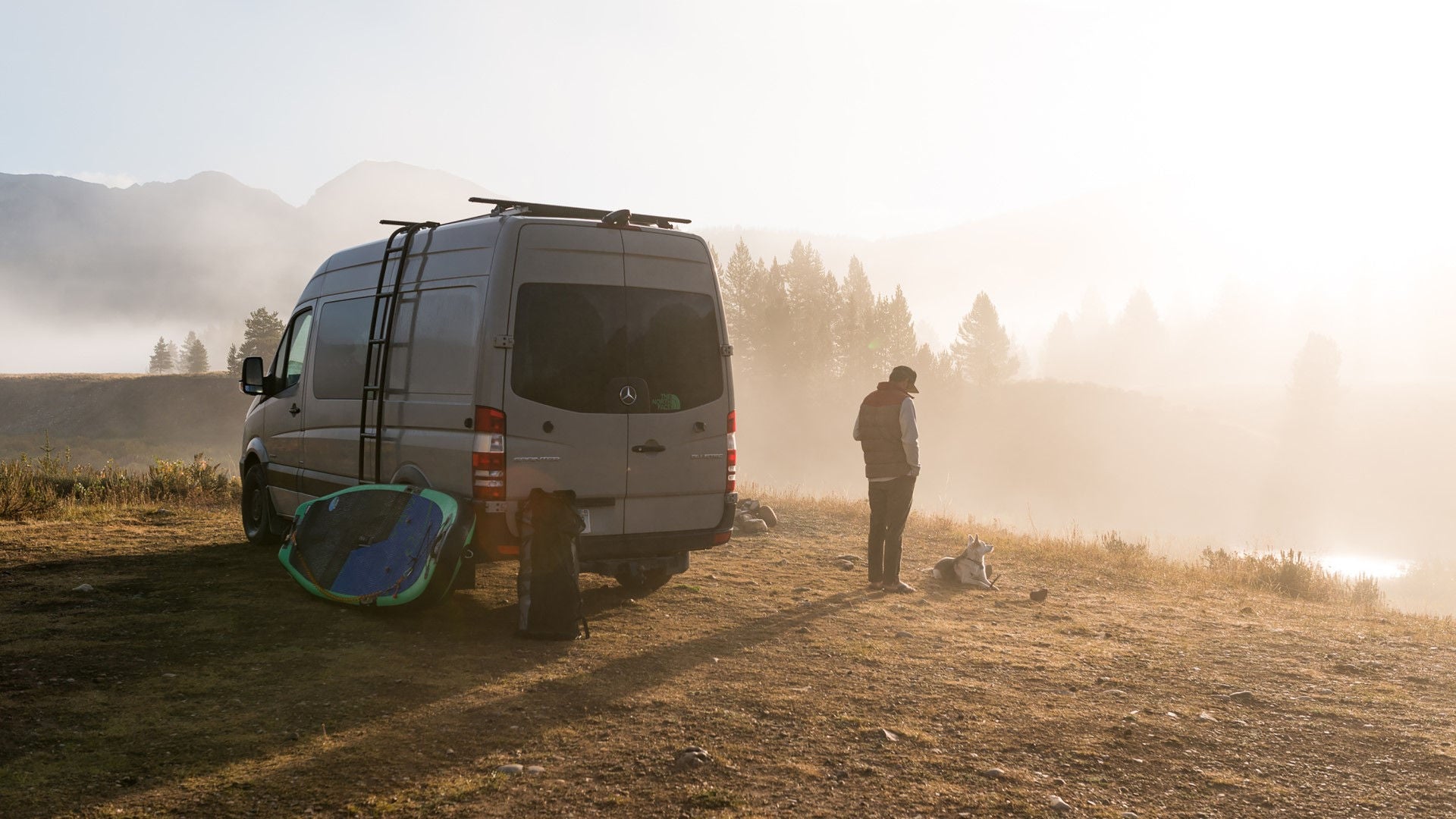 Man in front of camper can in the mountains