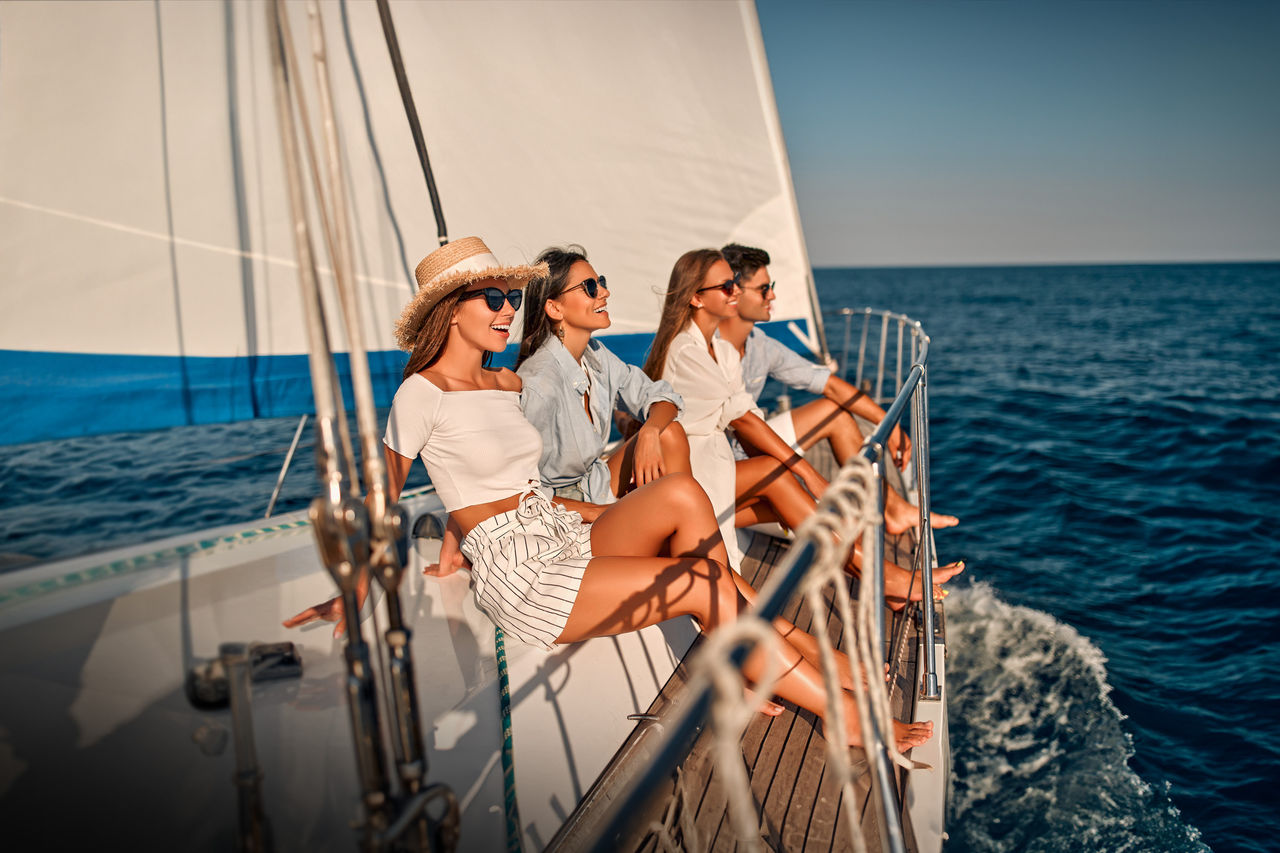 Four people on a sailing boat on the ocean